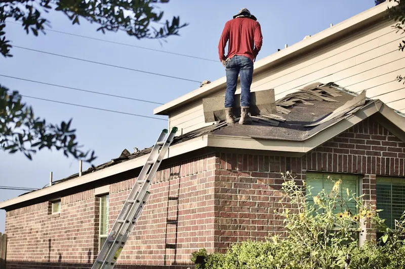Professional roofer working on a residential roof in Thoroughbred Farms